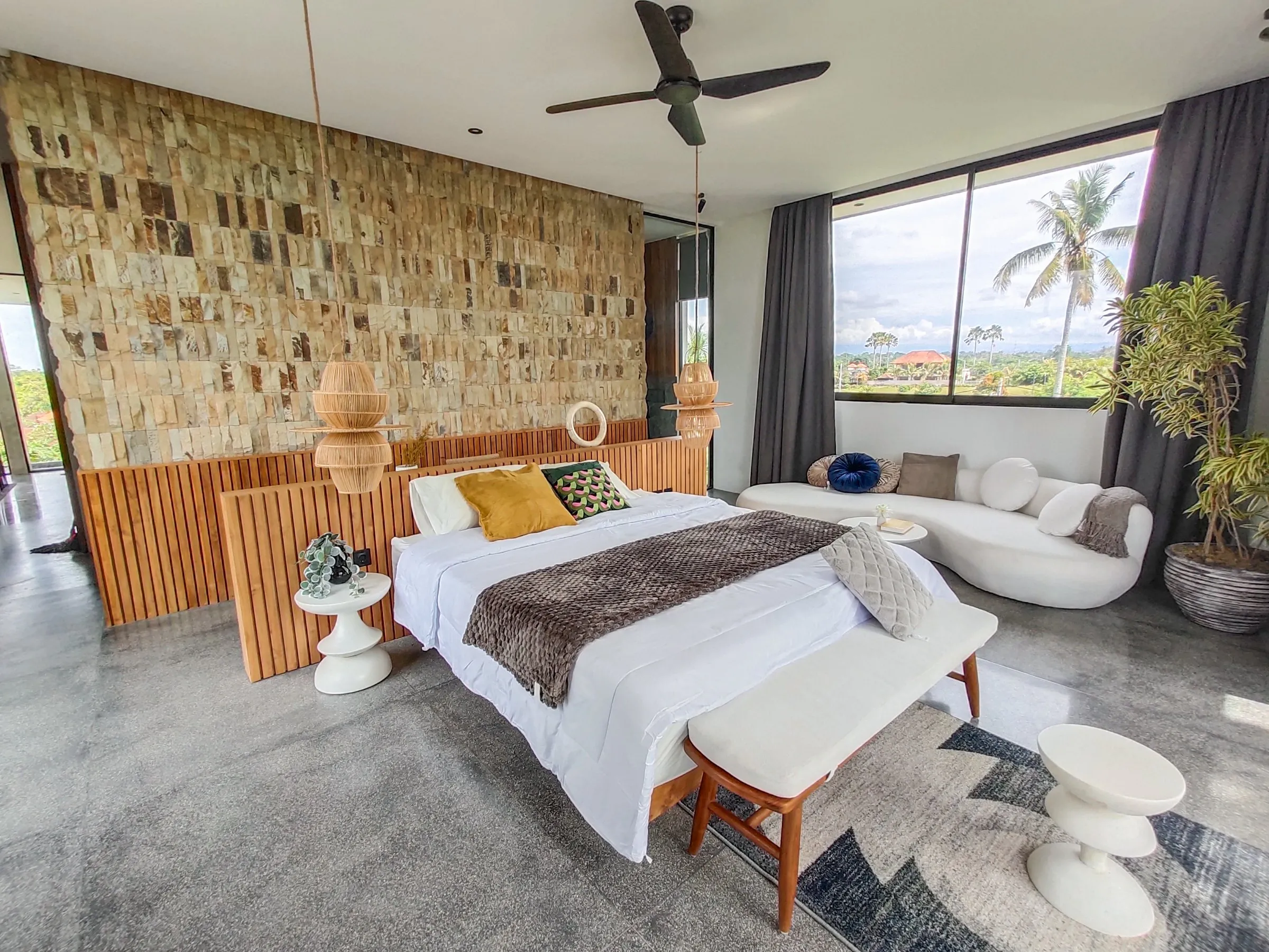 Low teak bed frame with a slatted teak headboard wall and matching bench.