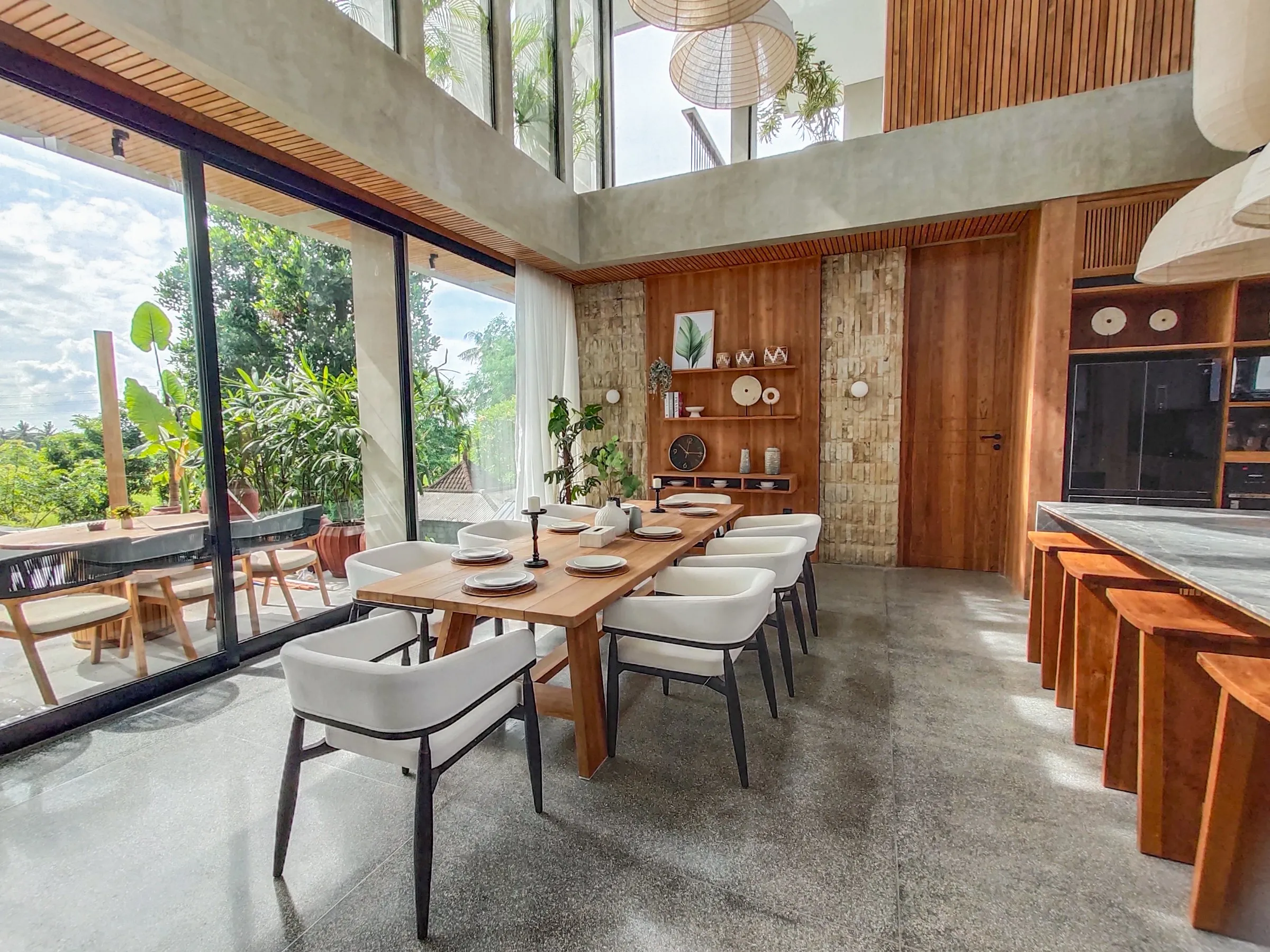 Teak dining table and wall joinery in the double-height dining room.