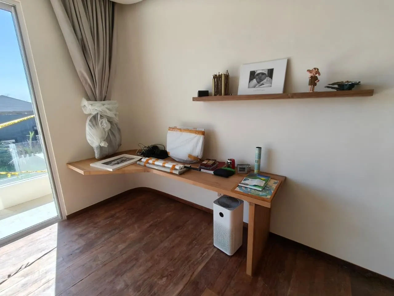 Teak corner desk with a floating shelf.