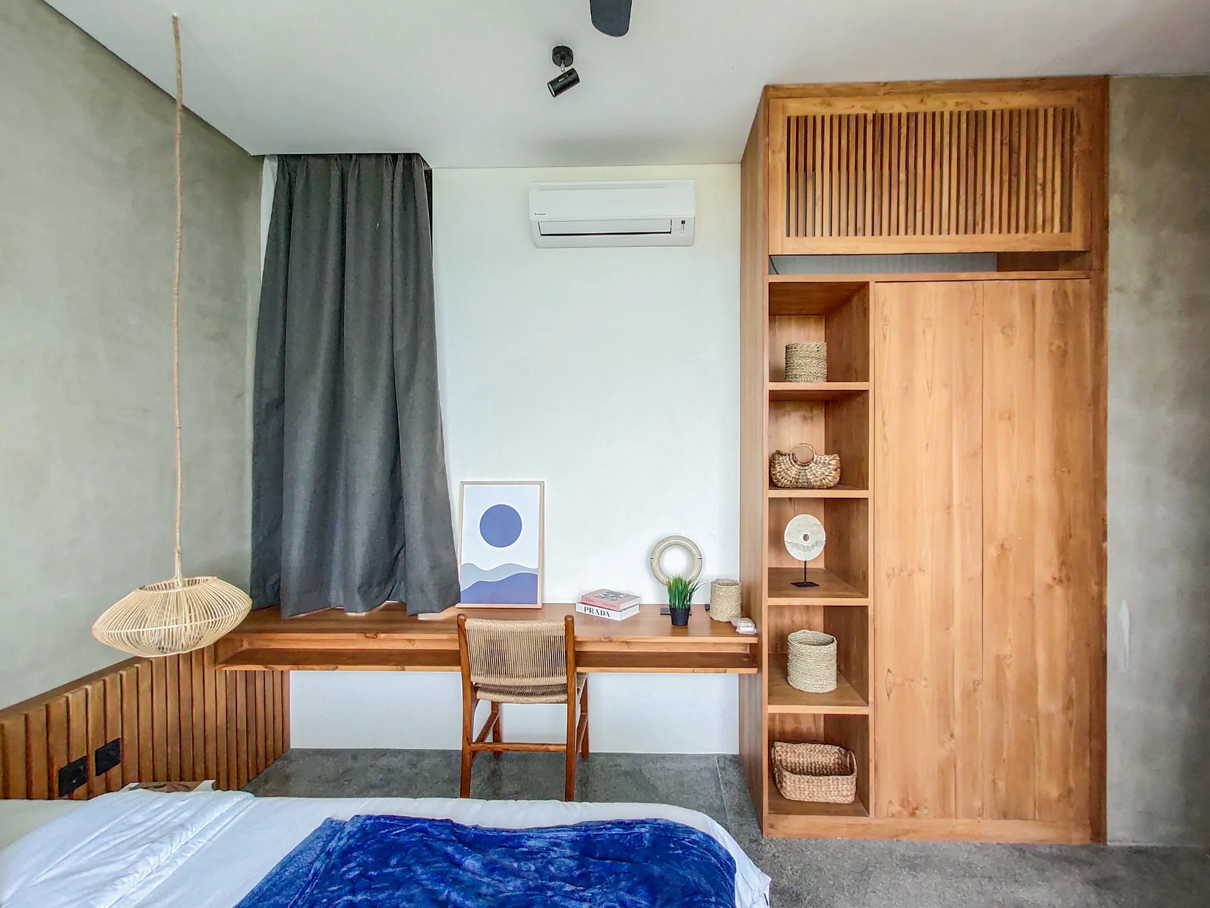 Bedroom with a built-in teak desk, wardrobe and shelving.