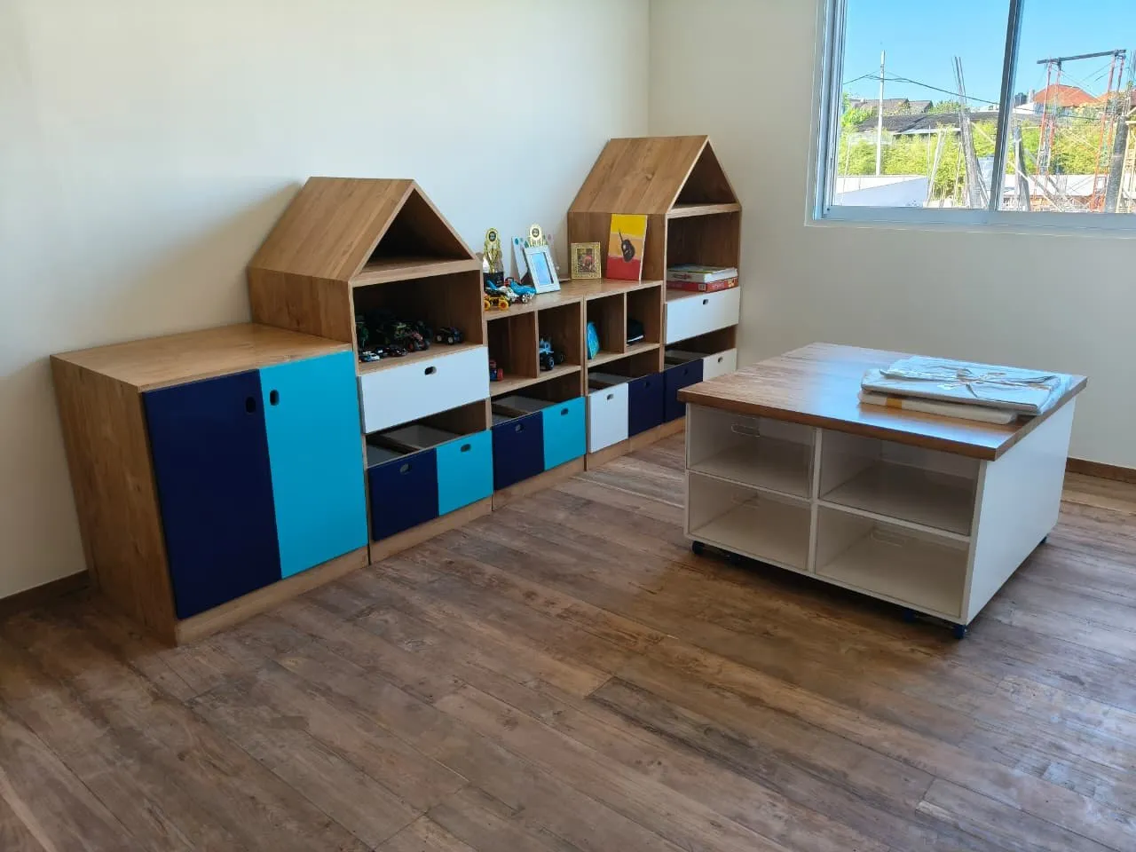 Children's storage units in teak and painted panels.