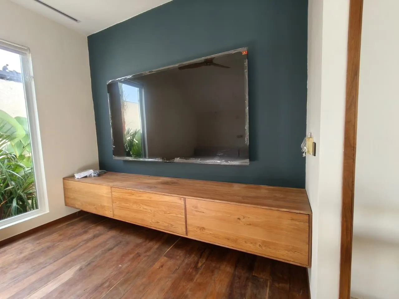 Low floating teak media console.