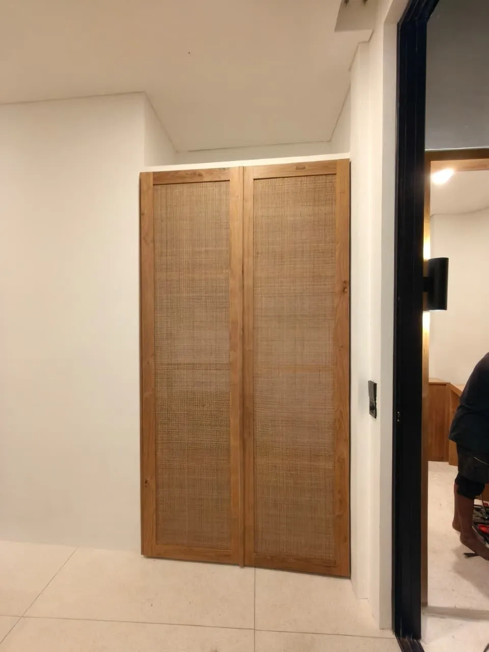 Teak wardrobe with rattan door panels.